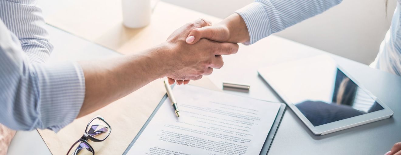 A handshake happening in a meeting