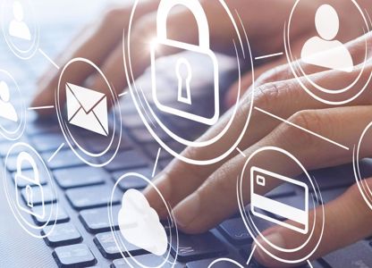 A person typing on their laptop with a digital graphic overlay