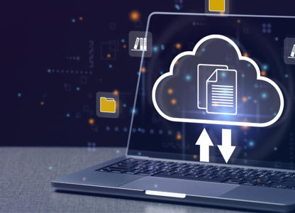 Laptop displaying a glowing cloud icon with upload and download arrows