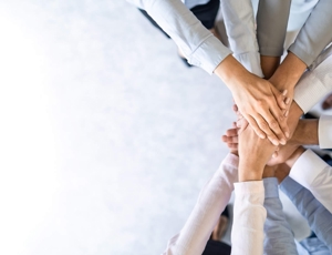 People putting their hands in the middle