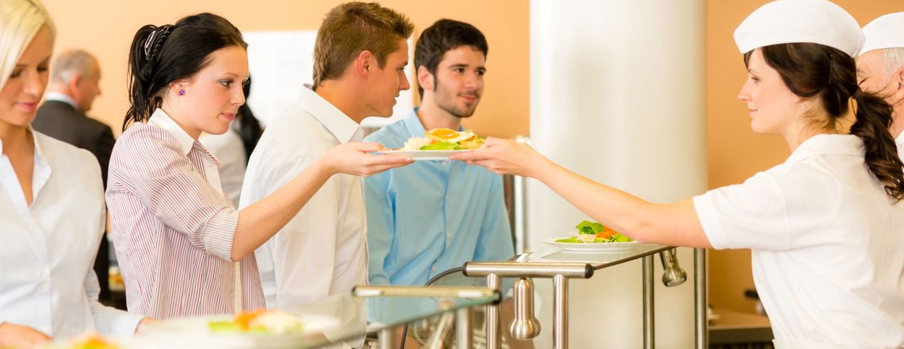 People getting served food in a canteen