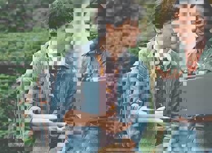 Two people smiling at a laptop