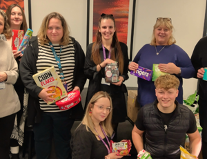 procurement services team holding food donations