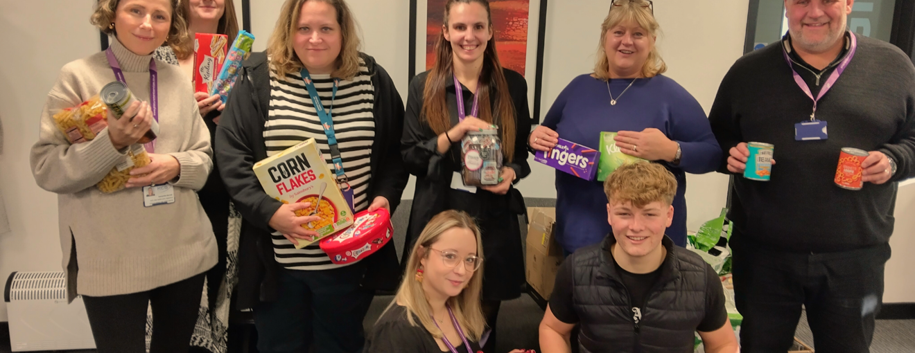 procurement services team holding food donations