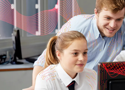 Teacher and pupil looking at a computer